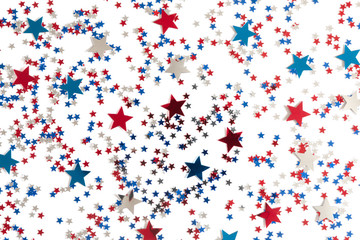 4th of July American Independence Day. Red, blue and white star confetti decorations on white background. Flat lay, top view, copy space