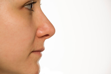 Clseup profile of woman without makeup on white background