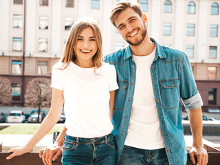 Portrait of smiling beautiful girl and her handsome boyfriend. Woman in casual summer jeans clothes. Happy cheerful family. Female having fun on the street background