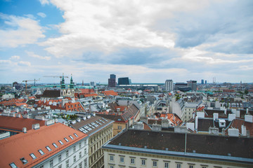 City skyline view of Vienna Austria from the monastery tower with colorful roofs and blue sky as tourism memory card from vacation and travel concept for blogs about famous landmarks in the city