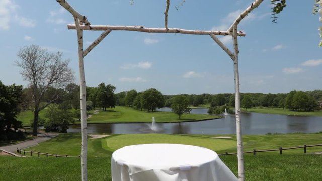 Move from golf course view out to reveal wedding canopy