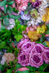 Background of pink and yellow paper flowers. Artificial flowers. Floral background.