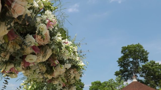 Slow motion wedding canopy flowers outside