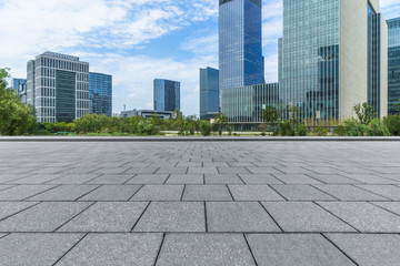 empty pavement and modern buildings in city.