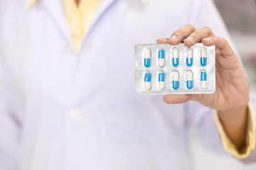 capsule in the women pharmacist hand