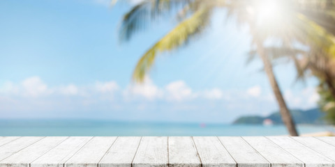 Empty wood table top and blurred summer beach with blue sea and sky banner background. - can used...