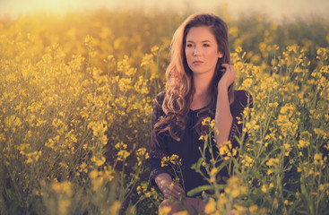 Portrait of beautiful woman in rapeseed field