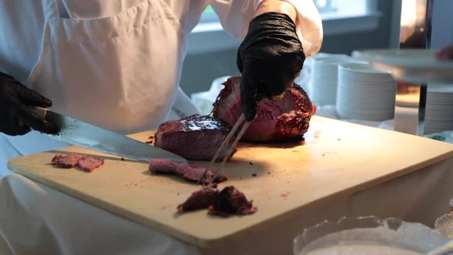Separating pieces of steak on carving station
