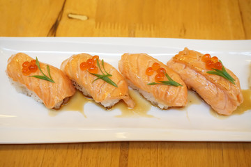Grilled salmon sushi - Set of salmon aburi sushi topped with sweet sauce and salmon roe (Ikura), Traditional Japanese Food.