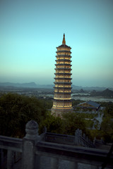 Bai Dinh Pagoda in Vietnam. Evening view against the sky and Vietnamese green landscape. Religious complex in Ninh Binh