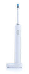 Electric toothbrush on a charging pedestal isolated on white background