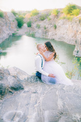 Elegant gentle stylish groom and bride near river or lake. Wedding couple in love 