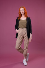 Attractive young redhead woman looking at the camera