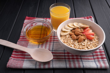 Oatmeal. Breakfast. Vegetarian food. Honey, nut, strawberry, juice. Diet healthy meal