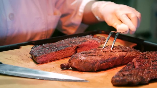 Close up separating steak on cutting station