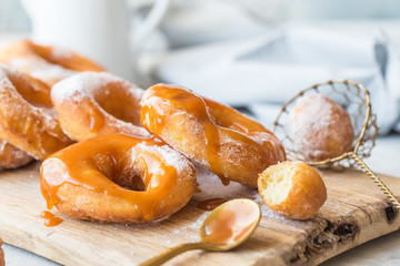 Glazed caramel doughnuts. A close up of fresh glazed doughnuts in a studio setting. donut