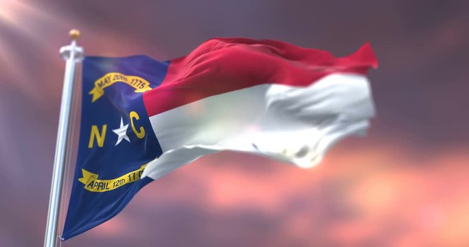 Flag of american state of North Carolina waving at sunset - loop