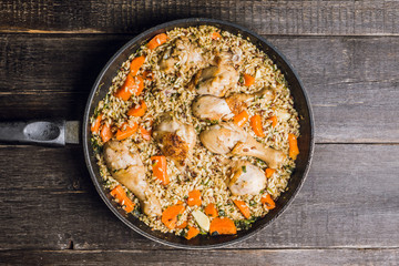 Fried rice with vegetables and chicken in pan. Selective focus.