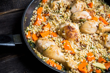 Fried rice with vegetables and chicken in pan. Selective focus.