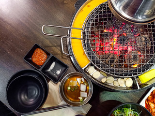 Grill and mesh grill of charcoal fire ( Bulgogi ).Table set of korean barbecue, meat , pork,...