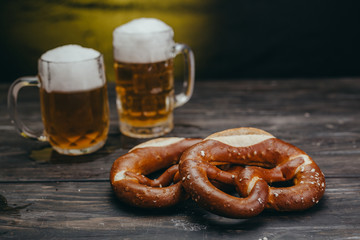 pretzels and beer on wooden table