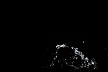 water splash drop to the ground on Black background . Close up of splash of water forming explode shape