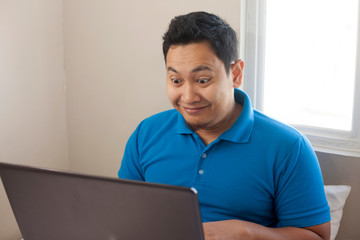 Male Entrepreneur Working Online Business From Home, Happy Smiling Expression Looking at Laptop