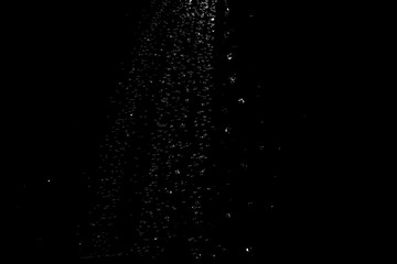 Naklejka na ściany i meble water splash drop to the ground on Black background . Close up of splash of water forming explode shape