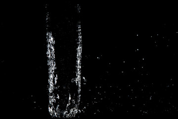 water splash drop to the ground on Black background . Close up of splash of water forming explode shape