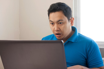 Man Shocked with Open Mouth to See Bad News on Internet