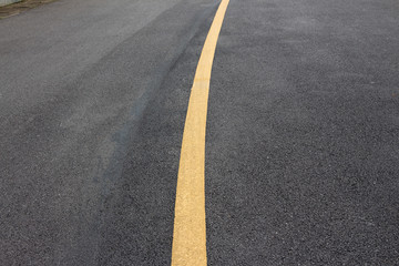 Yellow solid line asphalt pavement