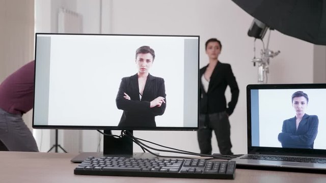 On the set of professional photoshoot. The pictures are showing on dual monitor setup