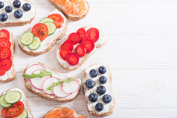 Variation of toast with fruit , vegetable and salmon