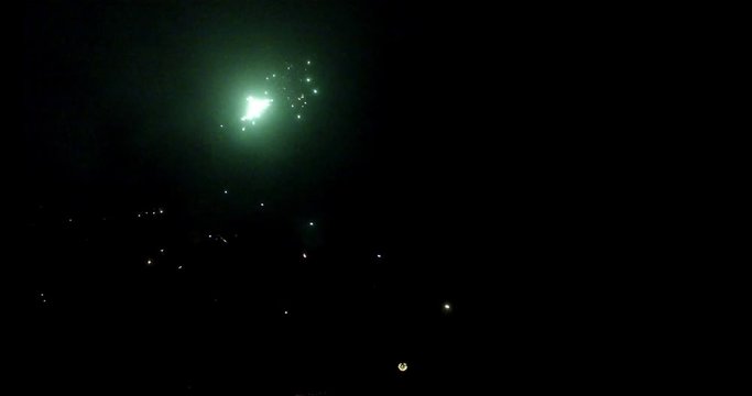 sparkling fireworks at night from a drone flying into the rockets, 