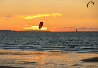 Sunset and Kitesurfers on the beach in Saint Malo,  Brittany, France
