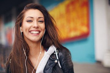 Young woman enjoys music on the street