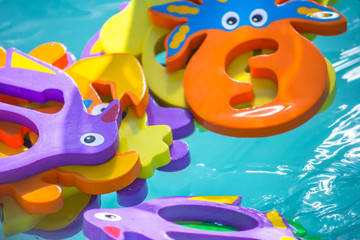 Fototapeta na wymiar Educational water game for children. Fish in the form of letters of numbers and images of animals and a net for fishing. Fun for kids