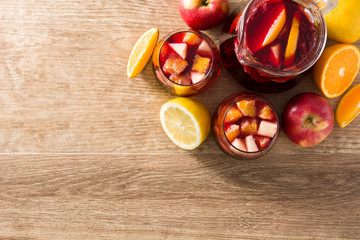 Red wine sangria in glasses on wooden table. Top view. Copyspace