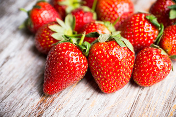Ripe strawberries on the rustic background. Selective focus.
