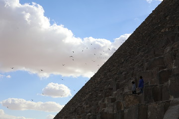 pyramid and blue sky with clouds