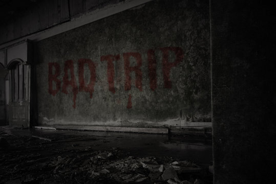 text bad trip on the dirty wall in an abandoned ruined house