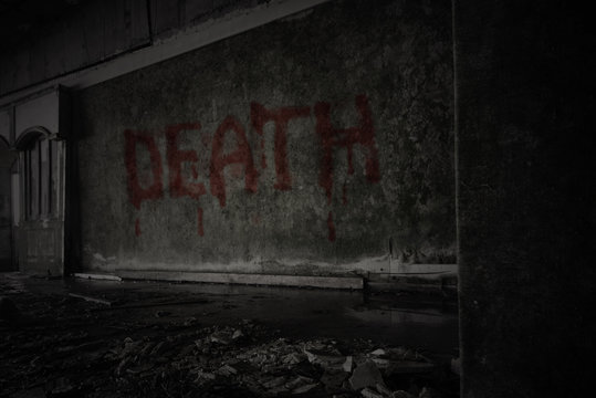 text death on the dirty wall in an abandoned ruined house
