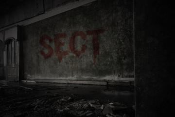 text sect on the dirty wall in an abandoned ruined house