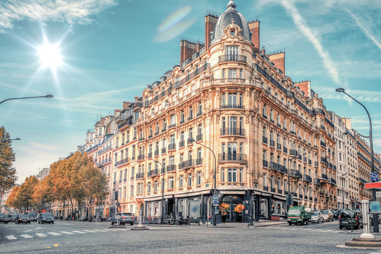 Fototapeta Streets of Paris, France. Blue sky, buildings and traffic.