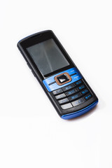 Old mobile phone on white background. Close up. Selective focus.