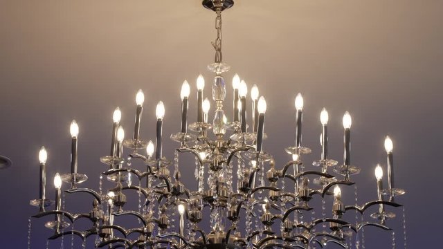 Close chandelier reveal from ceiling