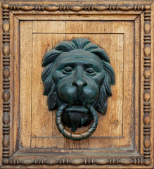Antique door handle in the form of a lion. Head