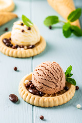 Homemade coffee and vanilla ice creamwith chocolate candies on blue background. Healthy summer food concept.