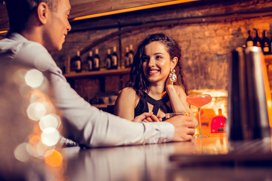 Girlfriend Smiling While Spending Time With Her Man In Bar