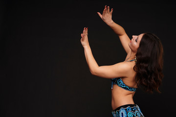 Beautiful belly dancer perfoming exotic dance in red flutter dress